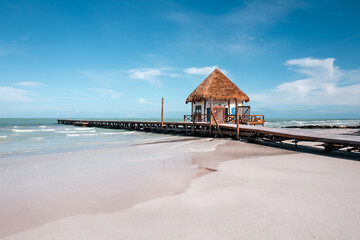 WOODEN PEER ON THE BEACH IN THE CARIBBEAN SEA, HOLBOX, MEXICO