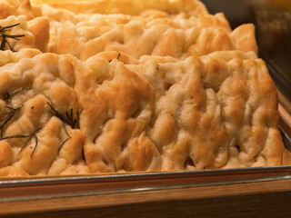 Ligurian focaccia with vegetables and pesto sauce in a shop