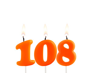 Lit birthday candle - Candle number 108 on white background.