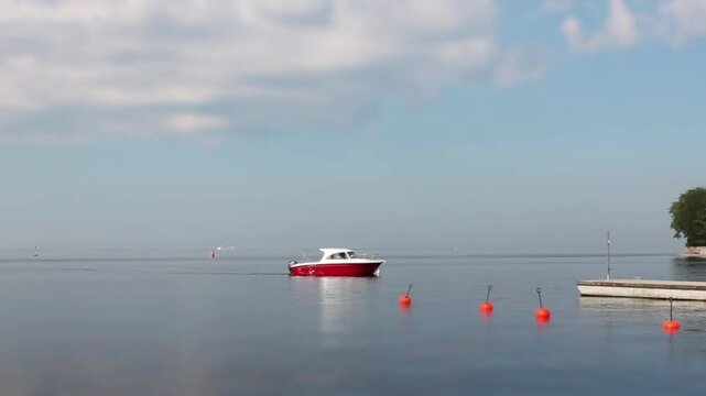 seascape with beautiful red motorboat, tilt shift