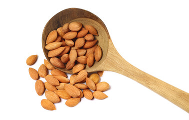 Apricot kernels in wooden spoon isolated on white background, top view