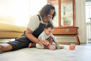 Mother, baby and play with toy blocks in home, learning and education in house. Development, care...