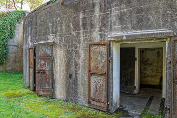 Fototapeta premium Rusty metal doors open to an underground military bunker at Fort Columbia State Park, Washington, USA