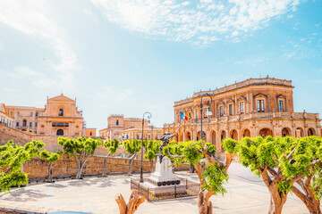 view in Noto, with the Basilica Minore di San Nicolo and Palazzo Ducezio, Sicily, Italy. Palazzo...