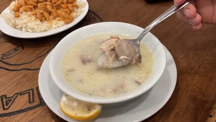 A Hearty Serving of Turkish Lamb Soup, Featuring Tender Meat and a Garnish of Lemon on Side
