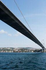 View of Istanbul coastline from a ship under Bosphorus Bridge. Sunny day