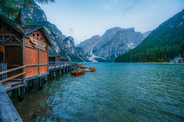 Lago di Braies or Pragser Wildsee lake with boats and fishing dock.Fanes-Sennes-Braies national...