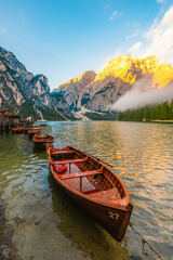 Obraz premium Lago di Braies or Pragser Wildsee lake with boats and fishing dock.Fanes-Sennes-Braies national park in Dolomiti Alps, South Tyrol, Italy
