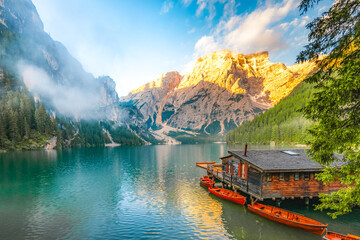 Lago di Braies or Pragser Wildsee lake with boats and fishing dock.Fanes-Sennes-Braies national...