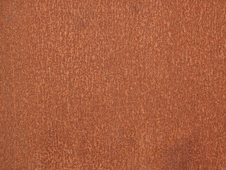 Close-up of house exterior iron door texture with rust effect. Brown and orange weathered rusty corroded metal finish surface.