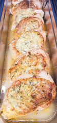 Savory baked chicken breast with herb stuffing served in a glass dish