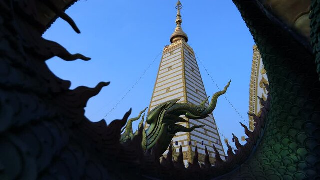 Background of the video of a religious tourist attraction, Wat Phra That Nong Bua, Ubon Ratchathani Province, Thailand. The beauty of the temple and the beautiful sculptures.