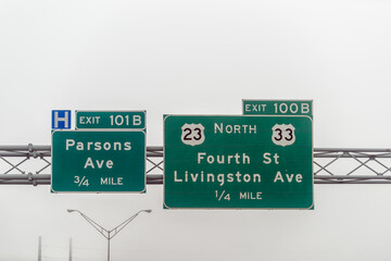 Columbus, Ohio highway 70 road in midwest city with fog mist cloudy day, exit signs for Parsons and Livingston Avenue, Fourth street
