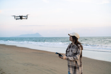 A woman is piloting a drone driving it from a remote control.