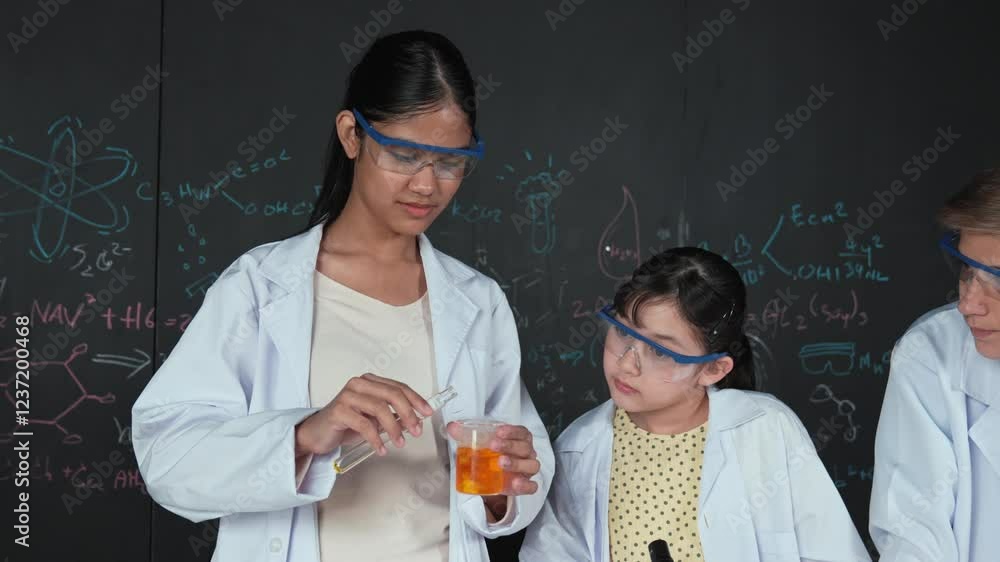 Poster diverse student mixing colored solution while doing experiment at table with microscope or tube with