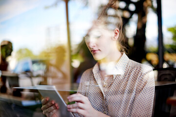 Tablet, online and woman in cafe for remote work, reading email or editing news for politics....