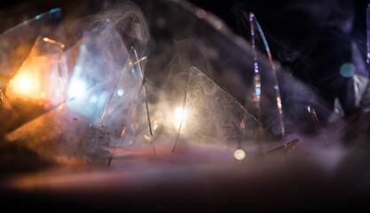 A silhouette of a person against the background of shattered glass. An abstract world made of glass shards. Surreal concept. Table top decoration.