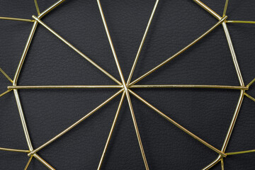 Modern gold lines metal geometric pattern on black leather background