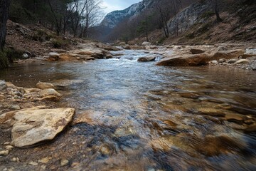 A serene mountain stream with rocky banks and clear flowing water, inviting for outdoor enthusiasts.