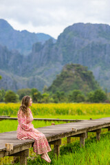 Woman relaxing on a wooden walkway