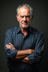 Fototapeta premium Grumpy Senior Manager Crossing Arms on Dark Background