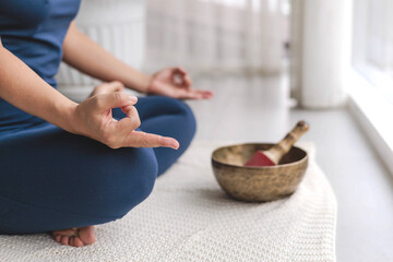 Unrecognizable yoga woman meditation in lotus position with mudra gyan gyana jnana hands closeup
