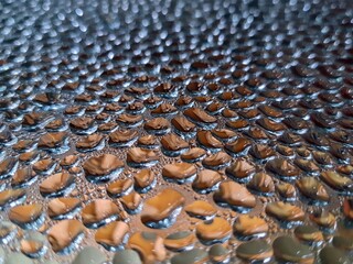 Fototapeta premium Water droplets on metal surface with selective focus