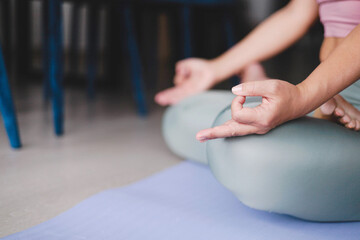 Unrecognizable yoga woman meditation in lotus position with mudra gyan gyana jnana hands closeup