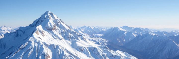 Obraz premium Majestic mountain landscape with serene atmosphere showcasing snow-covered peaks against a clear blue sky