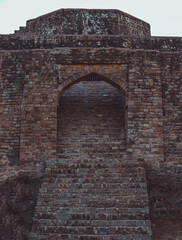 brick stairs leading to old medieval castle arched door