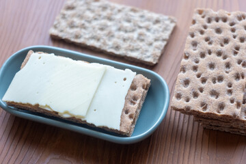 crispbread with cheese slice on the table in slow motion