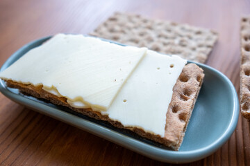 crispbread with cheese slice on the table in slow motion