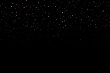 Dark black background with subtle golden starry speckles