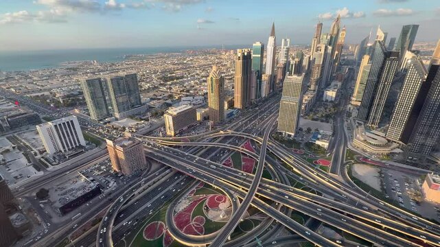 Dubai, UAE, Aerial video footage of highway interchange of  Sheik Zayed Rd and Al Safa St in Dubai Downtown with Cityscapes traffic, bridge, logistics. Roads and lanes, Crossroads, Cars 