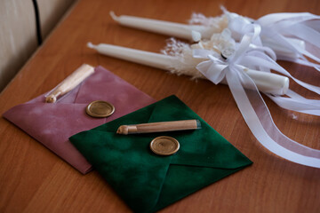 Elegant Sealed Invitations with Candles and Decorative Ribbons on a Wooden Surface