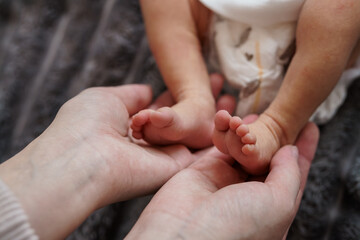 Tender Moment: A Parent's Hands Gently Cradling a Baby's Tiny Feet