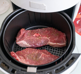 Close up of beef steak being cooked in white airfryer