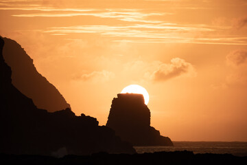 Sun rises behind the Motu Marotiri Stake and Cape Roggeveen on the southern side of the Poike...