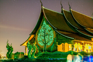 Background of the tourist attraction Wat Sirindhorn Wararam or the famous glowing temple in...