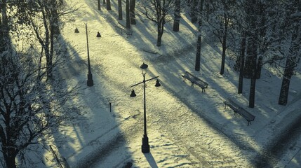 A winter city park abandoned due to avalanche warnings, snow-covered trees and lamp posts casting long shadows on icy paths