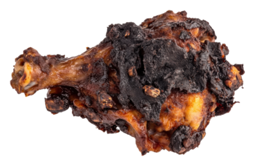 Charred chicken drumstick with burnt exterior isolated on transparent background