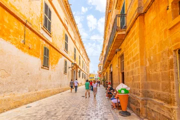 Fototapete Rund Enge Straßen A narrow street of shops and cafes leading to the Placa la Catedral square in the medieval old town of Ciutadella de Menorca, Spain, on the Balearic island of Menorca.  © Kirk Fisher