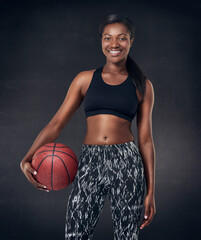 Black woman, portrait and basketball player in studio, fitness and ready for game on dark...