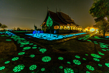 Background of the tourist attraction Wat Sirindhorn Wararam or the famous glowing temple in...