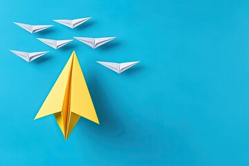 A vibrant yellow paper airplane leads a group of white paper airplanes, symbolizing creativity and innovation against a bright blue background.