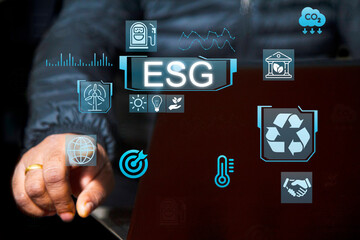 Businessman with ESG icon of saving clean energy environmental, social, governance, sustainable and corporation development, futuristic blue eco friendly, environment, go green, CO2, ESG concept