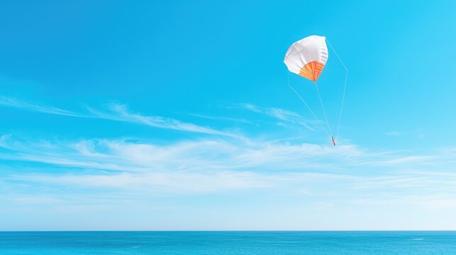 A person parasailing high in the bright blue sky above the calm turquoise ocean during a sunny day.