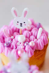 Easter Cute Bunny Cupcake with Pink Frosting. Catholic and Orthodox holidays.baked goods for spring holidays.Easter table setting 