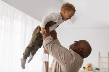 Best Grandfather. African American Grandpa Holding Little Grandson Up In Air Having Fun Spending...