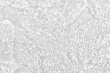 White water with ripples on the surface. Defocus blurred transparent white colored clear calm water surface texture with splashes and bubbles. Water waves with shining pattern texture background.